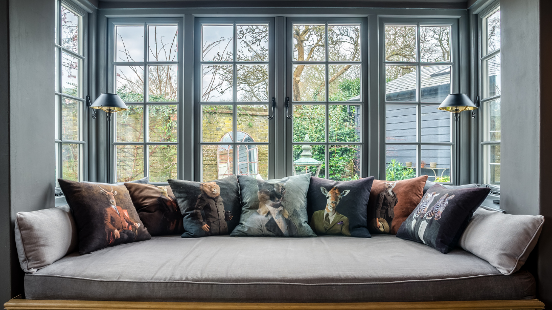 Evolution Storm2 casement windows in Dusty Grey. Window seat with cushions