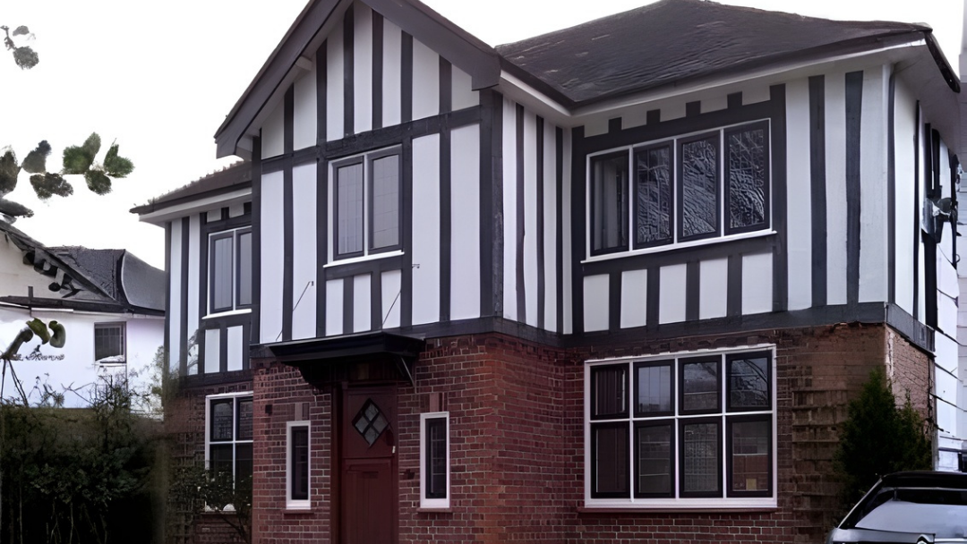Tudor style house with timber black windows with leaded design