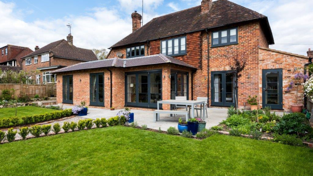 Rear of house with multiple timber doors and windows in Anthracite Grey (RAL 7016)