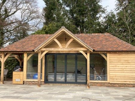 lack bi-fold doors with four panels on a garden room