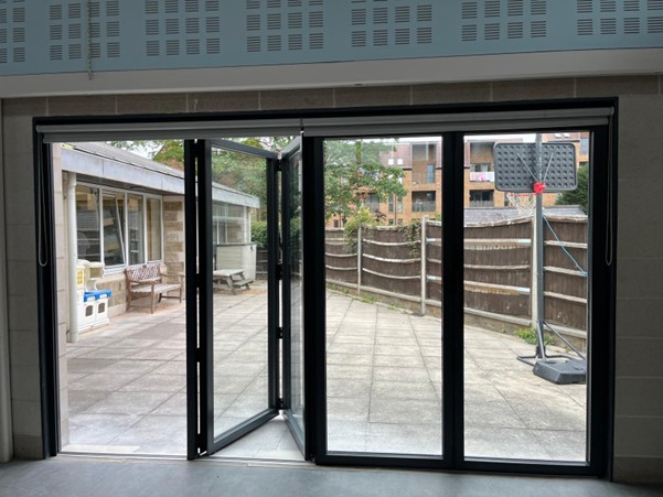 Black bi-fold aluminium doors leading out to a patio