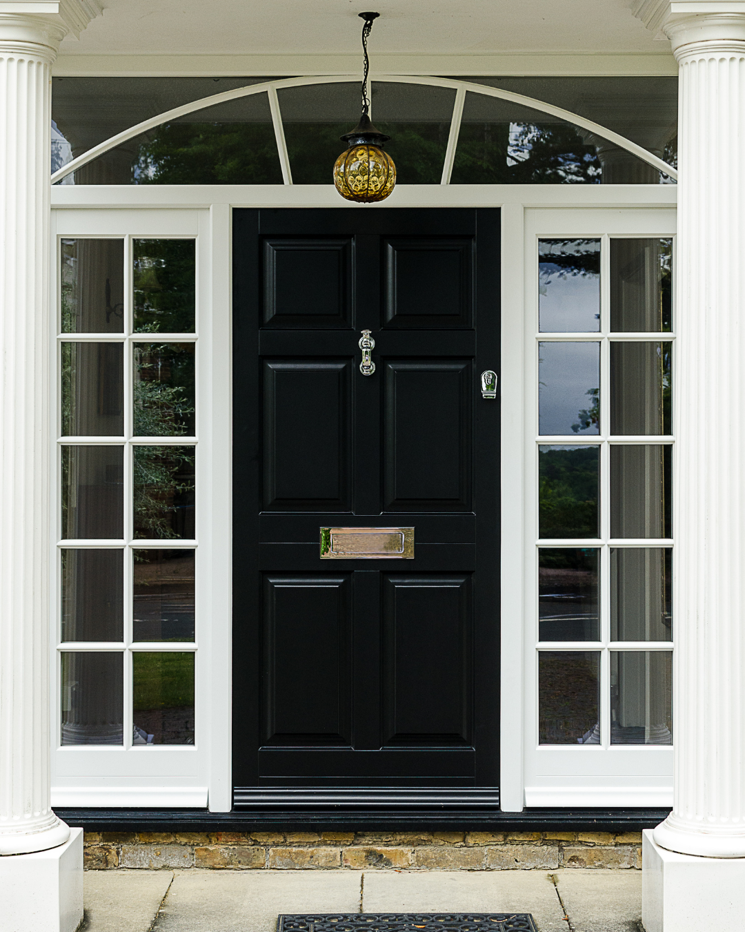 Black timber front door with side panels, top light and chrome furniture
