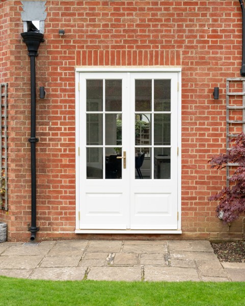 rectangle timber french doors in white with brass furniture