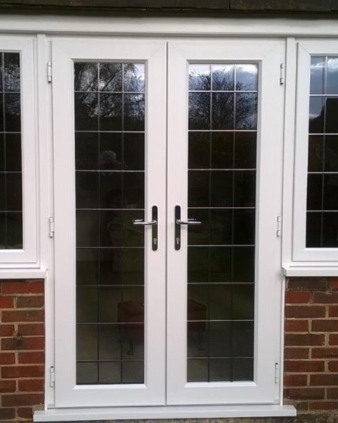 aluminium french doors in black in a wooden garden room