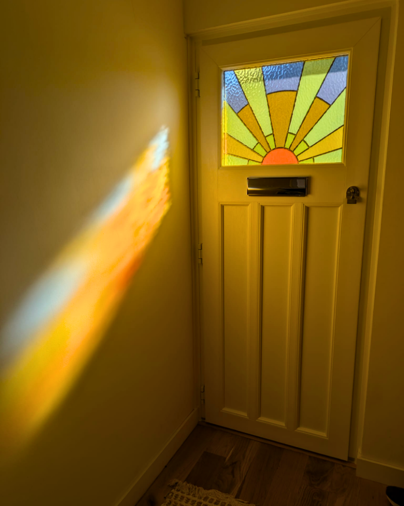 1930's front door with an art deco style sun in custom stained glass, timber alternative