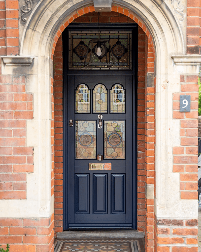 navy front door with custom stained glass, timber in a terraced house