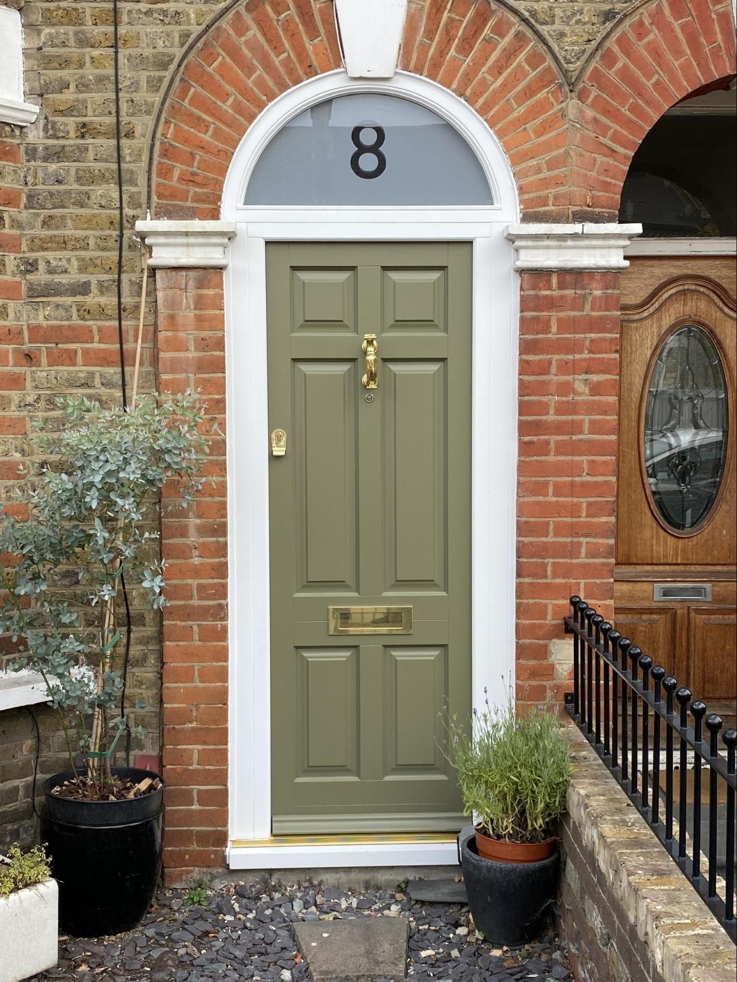 Timber front door with curved top light in Verdi green