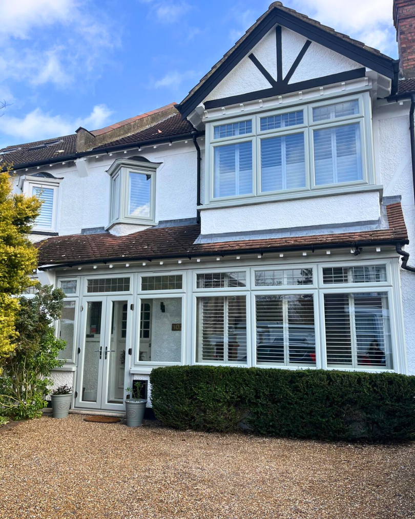 PVC bay windows in grey on white house, agate grey