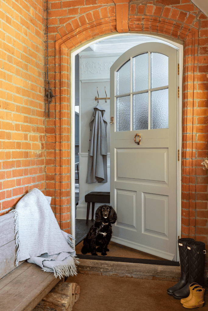 1930s British semi detached house cream front door red brick white bay windows traditional porch