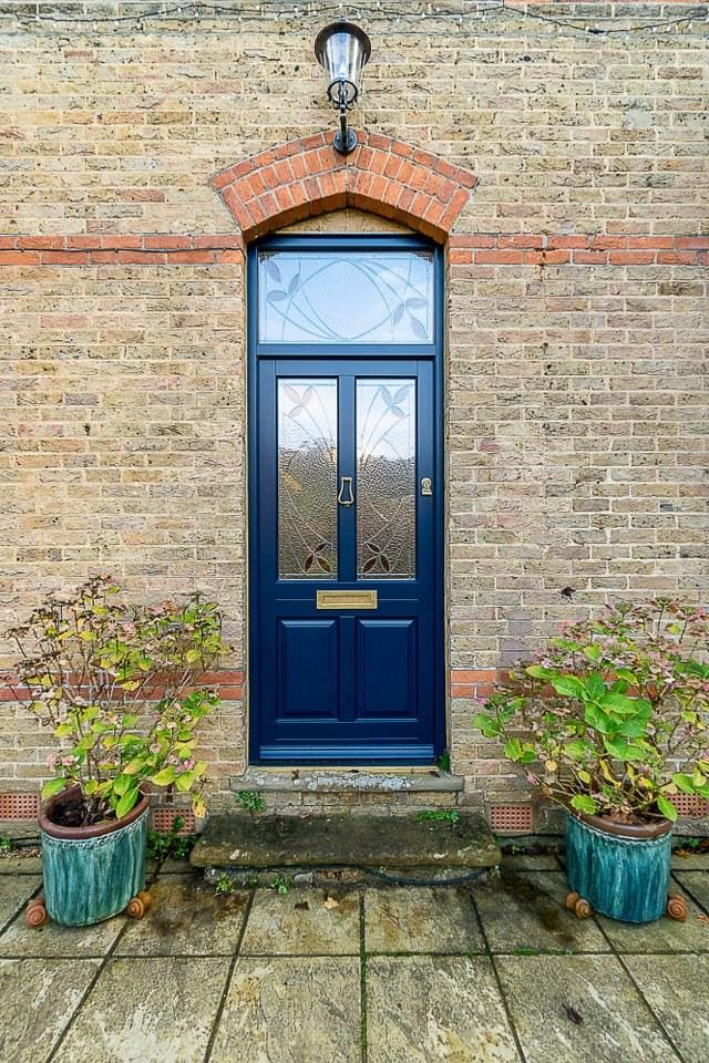 1930s British brick semi detached house navy blue front door