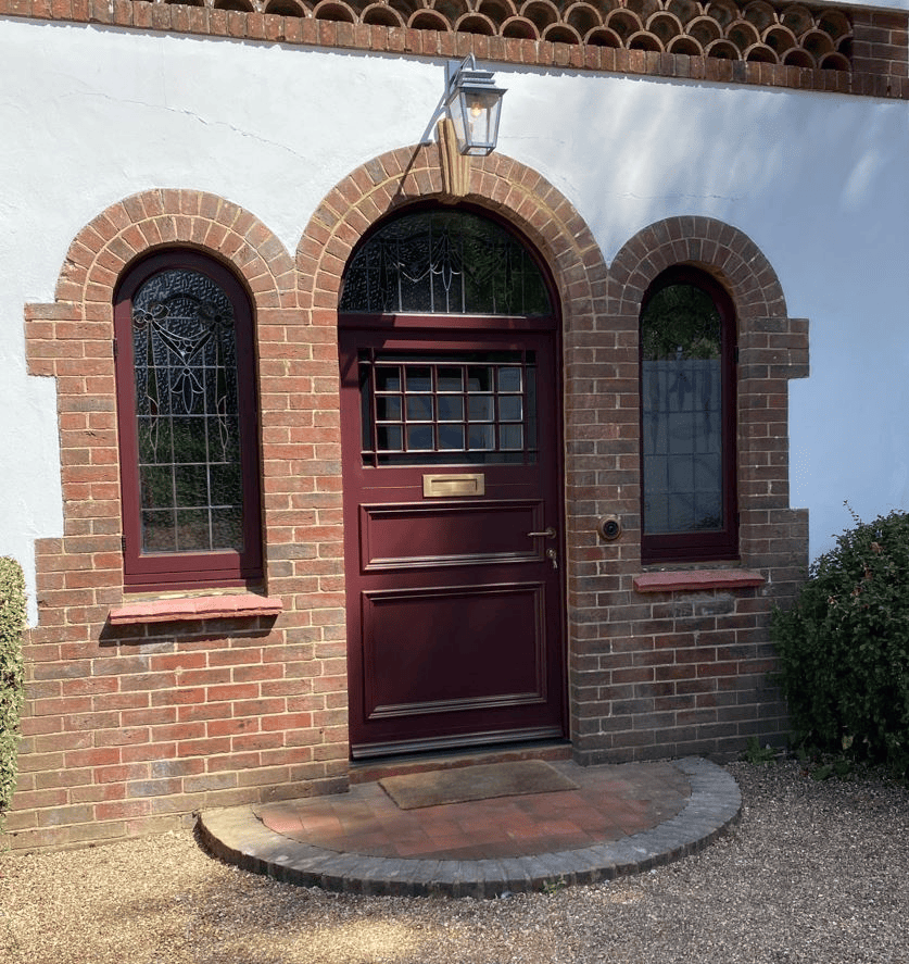 1930s English red brick semi detached house deep burgundy red front door traditional entrance